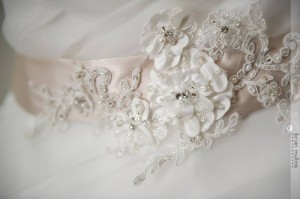 A rum pink appliqué belt by Gisele Bridal made the gown perfect.