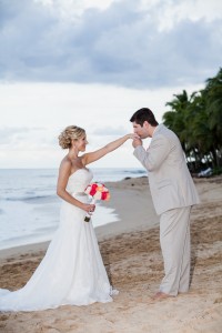 The couple married on the beach at sunset.