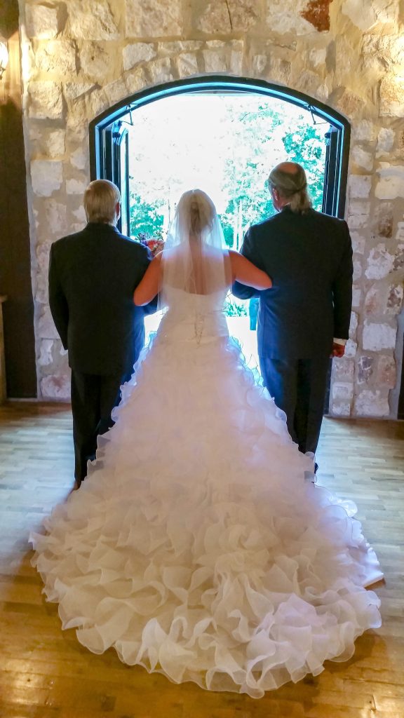 wedding dress cleaning customer walks down the aisle