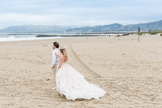 A beach wedding created a sandy hemline that needed expert wedding dress cleaning.