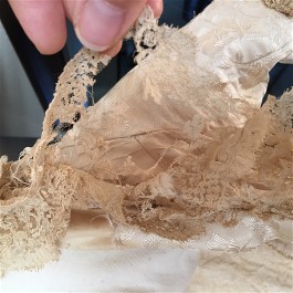 Vintage wedding dress restoration included replacing fragile torn lace with newer antique lace.