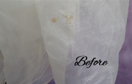 Oxidized spots on Abigail's grandmother's wedding dress before wedding gown restoration.