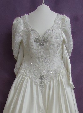Margaret's wedding dress after wedding dress restoration. It has been whitened and the beads look much better.