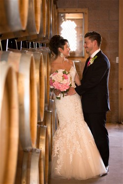 Jamie Locato and husband enjoy time on wedding day. Wedding dress preservation will protect Jamie's gown for years.