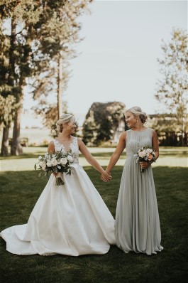 Kelsey and maid of honor enjoy the day. Wedding dress preservation will keep her gown in the best condition.