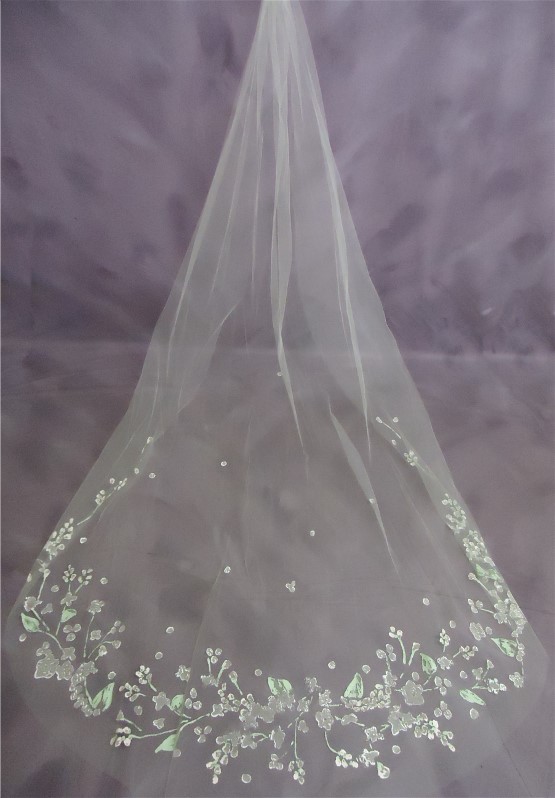 Rachel's hand painted veil is exquisite. Careful hand cleaning was included with ehr wedding dress cleaning and museum quality wedding dress preservation.