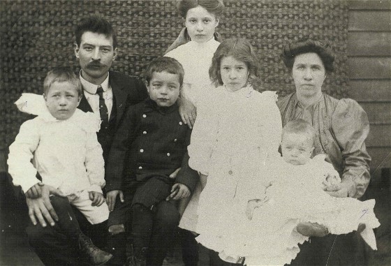 Henry Dallas Harrington with his family. Henry wore the uniform while working on his job as a street car conductor in Knoxville, Tennessee.