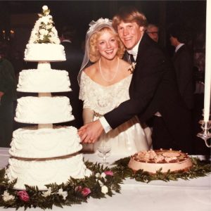 The bride grooms parents at their wedding eating wedding cake. Wedding dress restoration may make it possible for a third wedding for this gown.