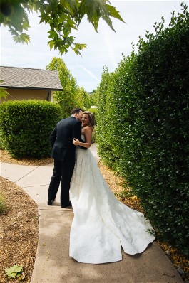 Melissa and new husband on wedding day. Wedding dress preservation will keep her wedding dress beautiful for years to come.