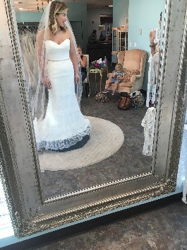 Kelsey checks out her gown choice in mirror. Notice the helpful nieces in the background.