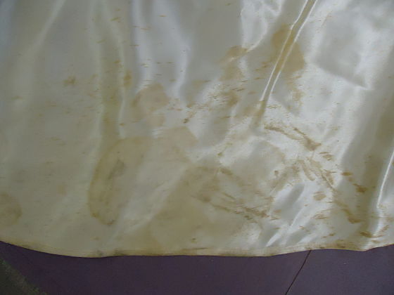 Monette's wedding dress train with stains before restoration.