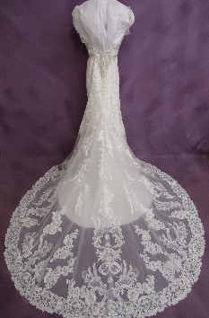 The back of Emily's Kittychen gown with beautiful Alencon lace overlay train after wedding dress cleaning and preservation.