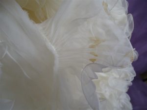 The oxidized stains on lauren's borrowed wedding dress required expert wedding dress cleaning.