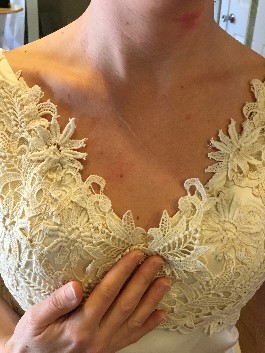 Laura's wedding dress with added lace at neckline.
